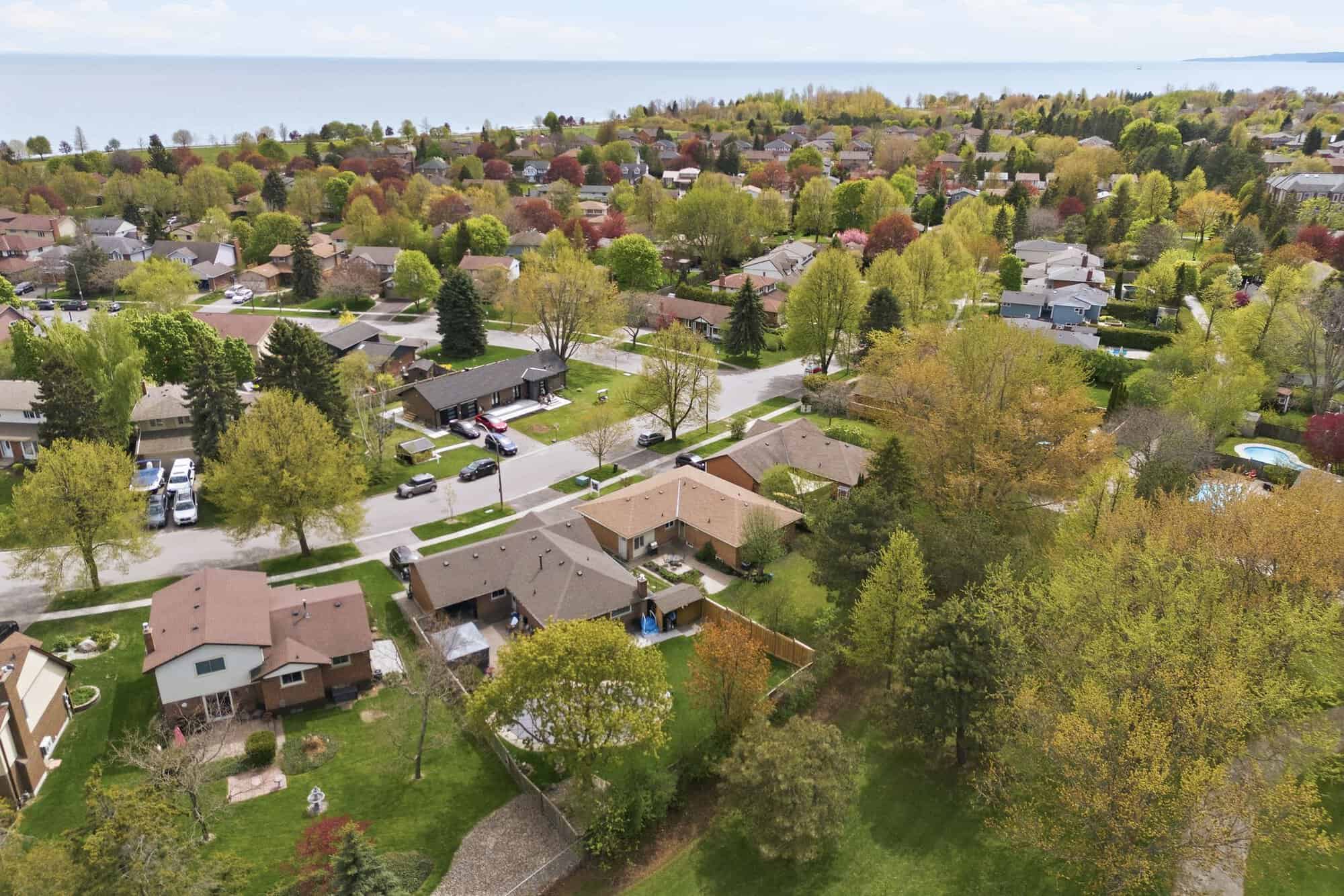 Aerial view of South Ajax near 39 Anstead Crescent, showing residential streets, mature trees and Lake Ontario