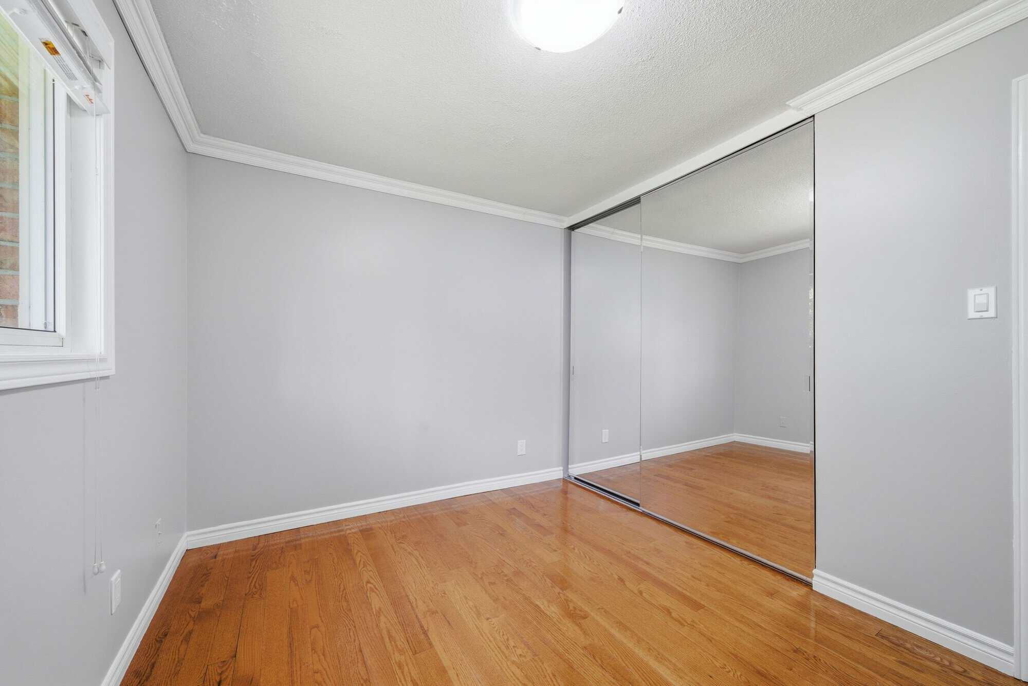 Main-floor bedroom at 39 Anstead Crescent, South Ajax, with a mirrored closet