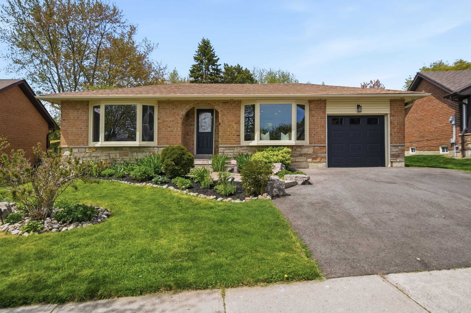 Front view of 39 Anstead Crescent, South Ajax, with landscaped gardens and a single garage