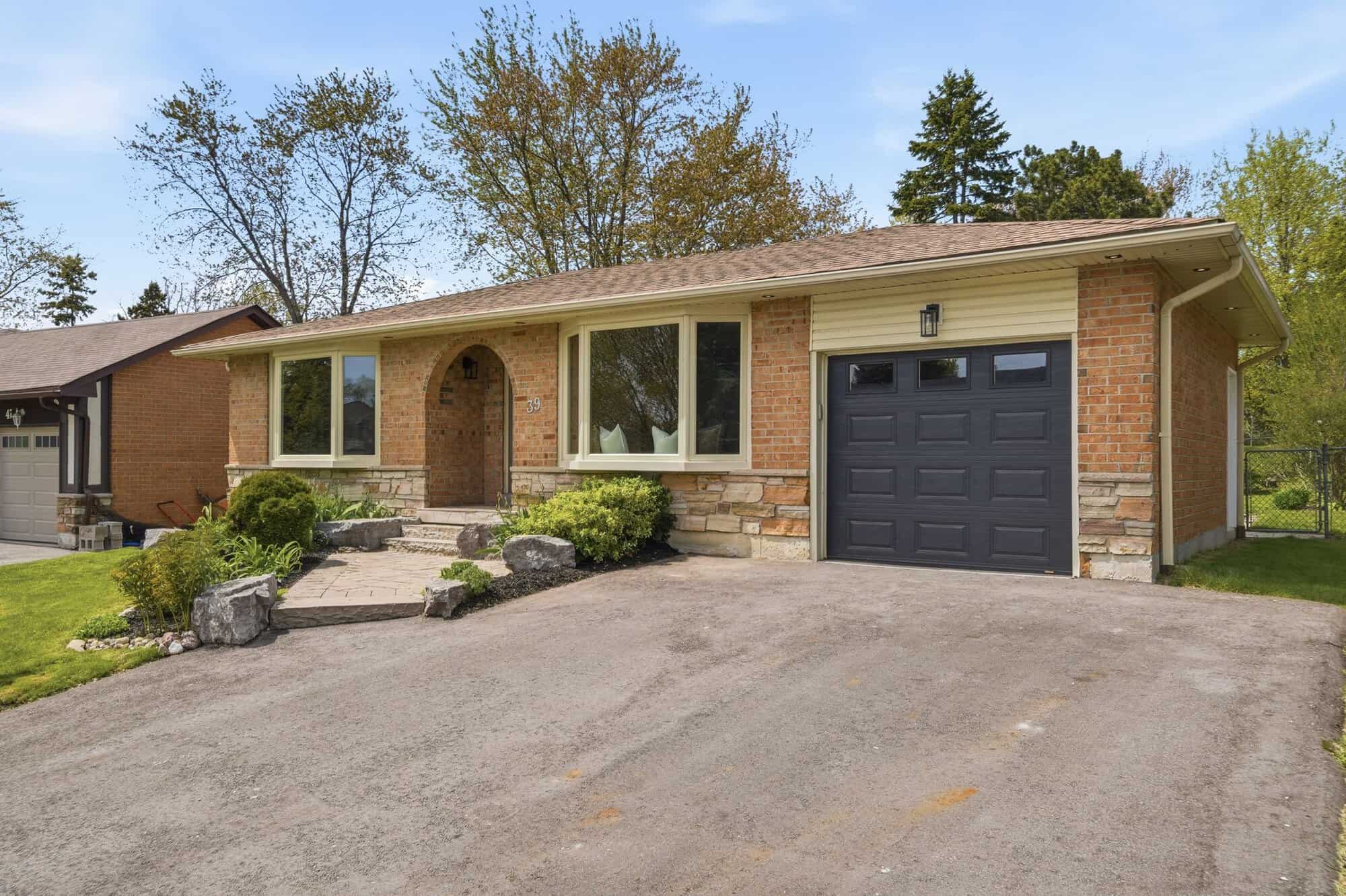 Front exterior of 39 Anstead Crescent, South Ajax, a detached bungalow with brick facade, driveway and garage