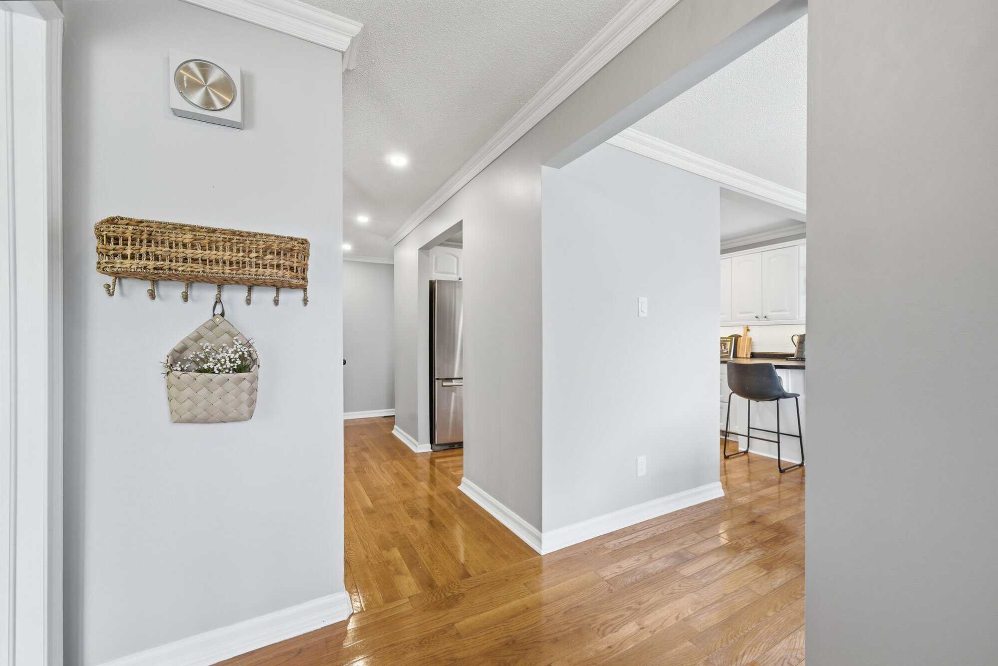 Interior hallway at 39 Anstead Crescent, South Ajax, with hardwood floors, pot lights and kitchen access