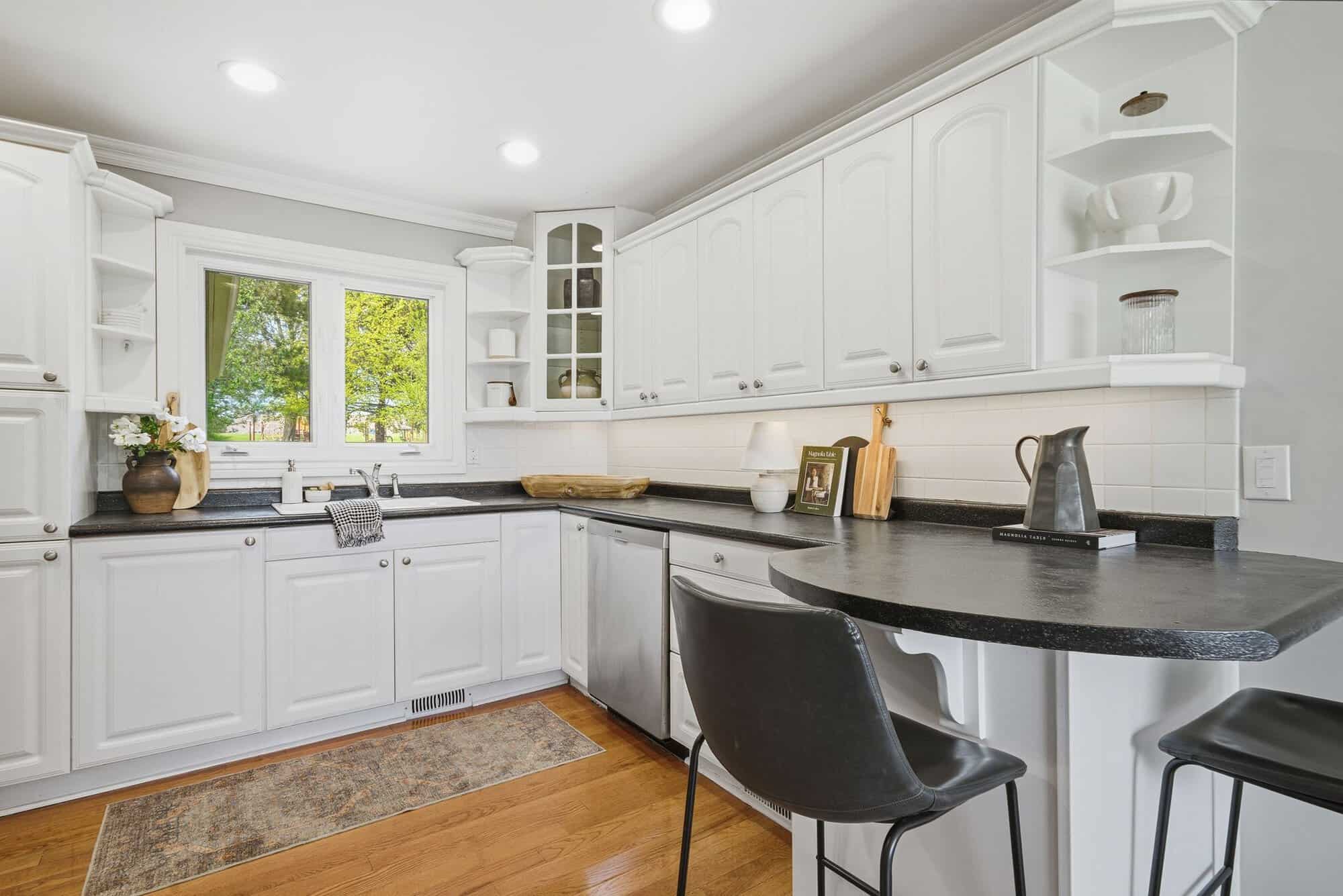 Kitchen at 39 Anstead Crescent, South Ajax, with white cabinetry, open shelving and a breakfast bar