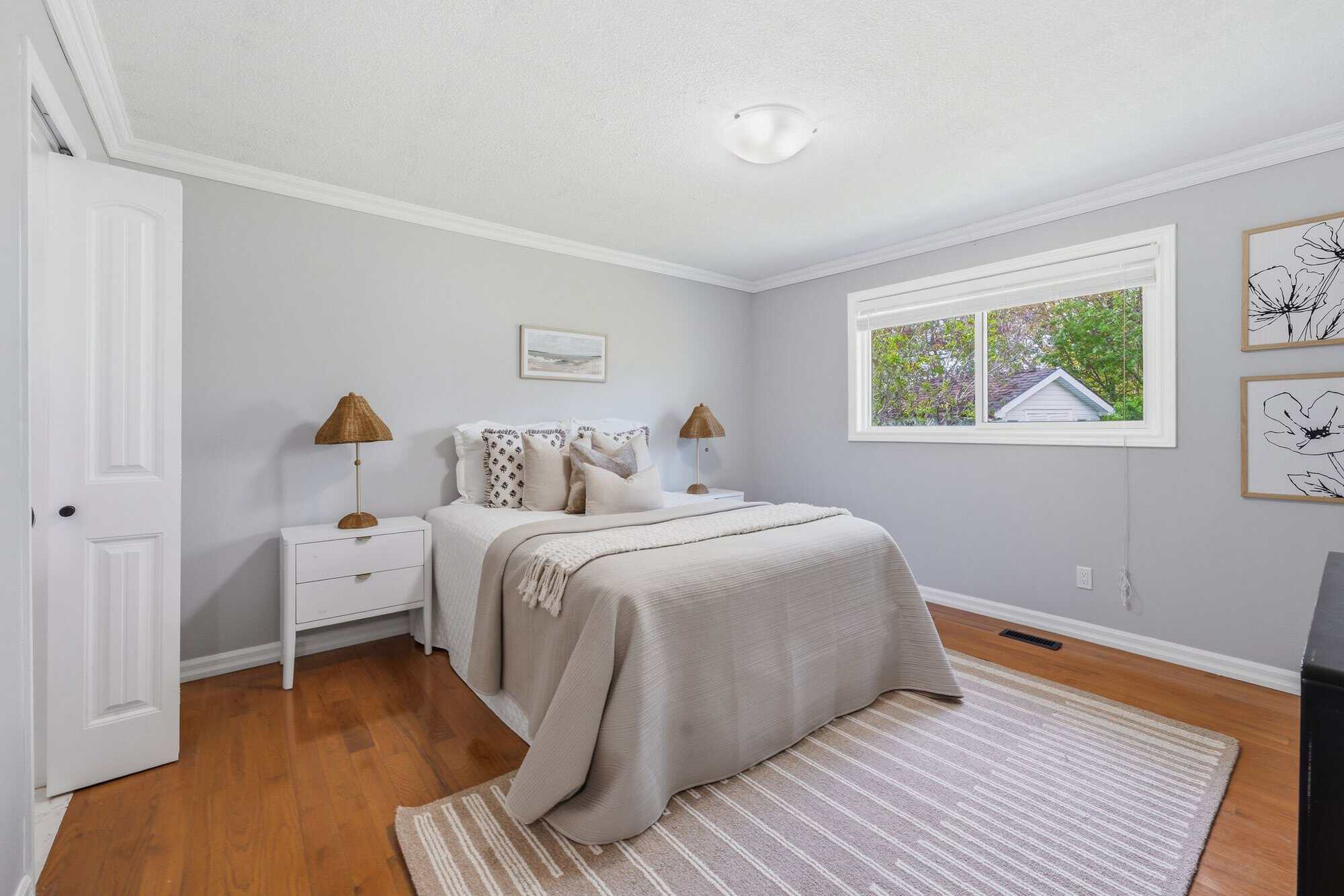 Primary bedroom on the main floor at 39 Anstead Crescent, South Ajax, with hardwood floors