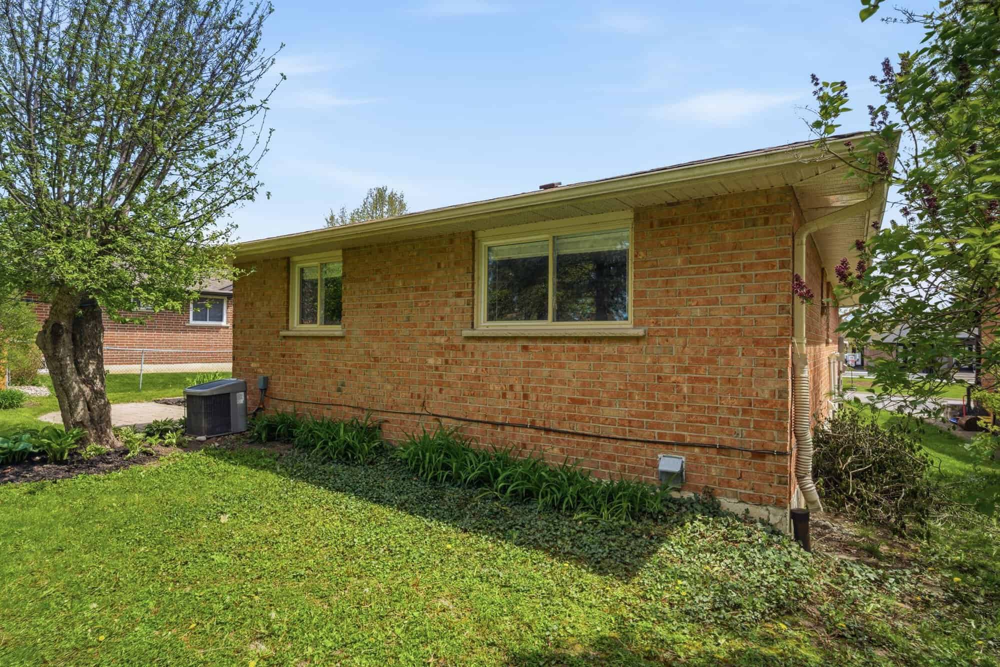 Side exterior of 39 Anstead Crescent, South Ajax, showing the brick facade