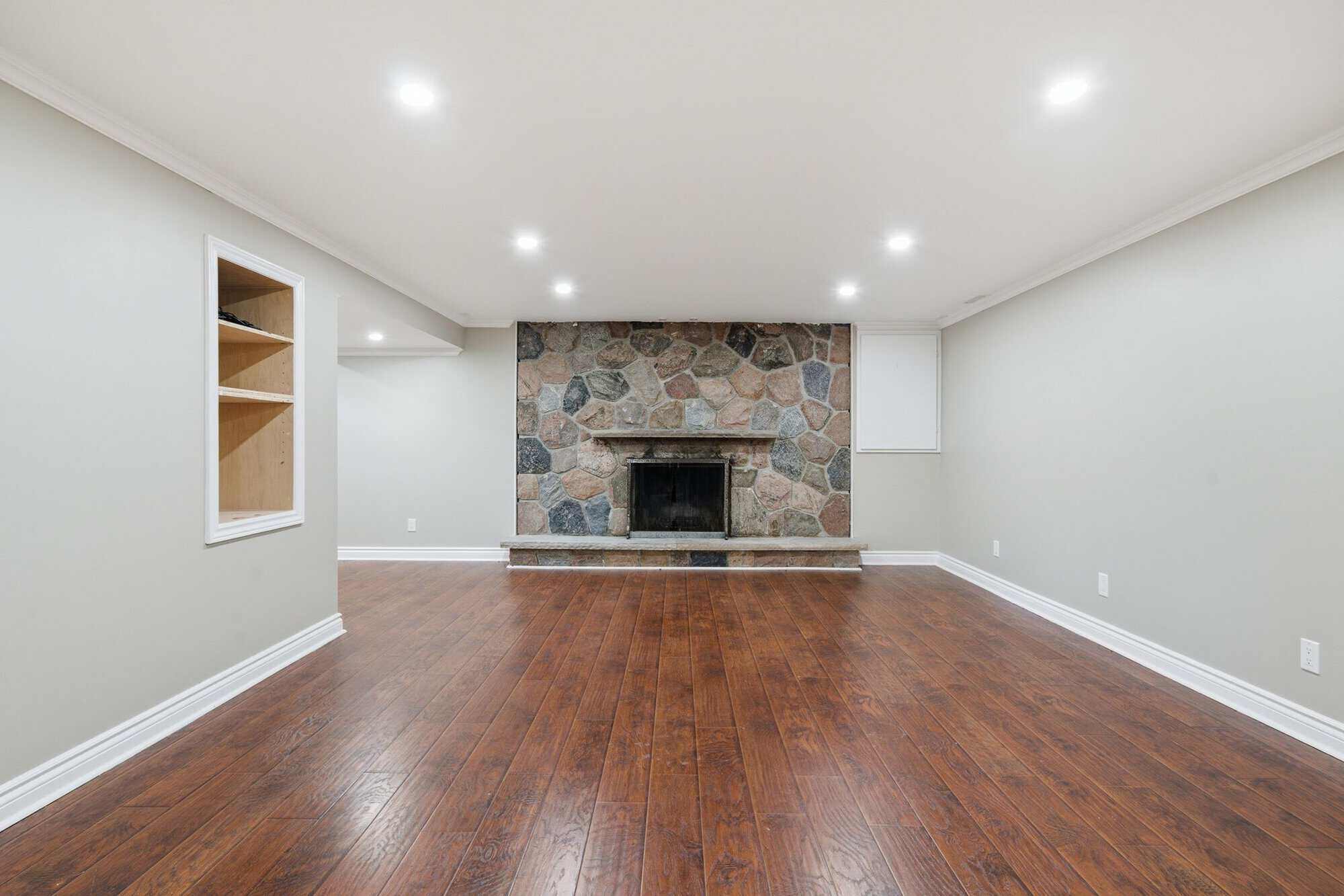 Finished basement rec room at 96 Bolland Crescent, South Ajax, with a stone fireplace