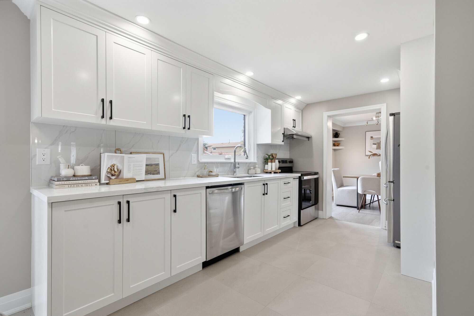 Renovated kitchen at 96 Bolland Crescent, South Ajax, with white cabinetry and quartz counters