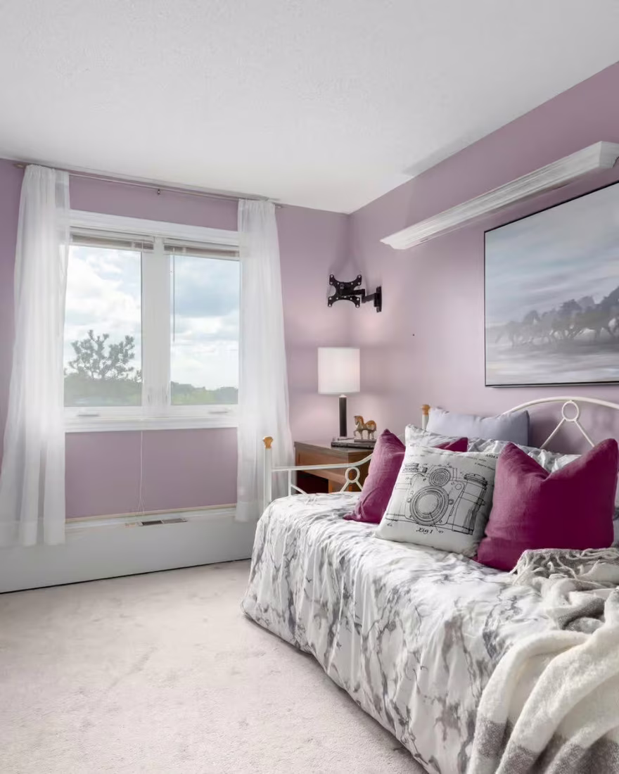 The same room staged as a tidy, inviting bedroom