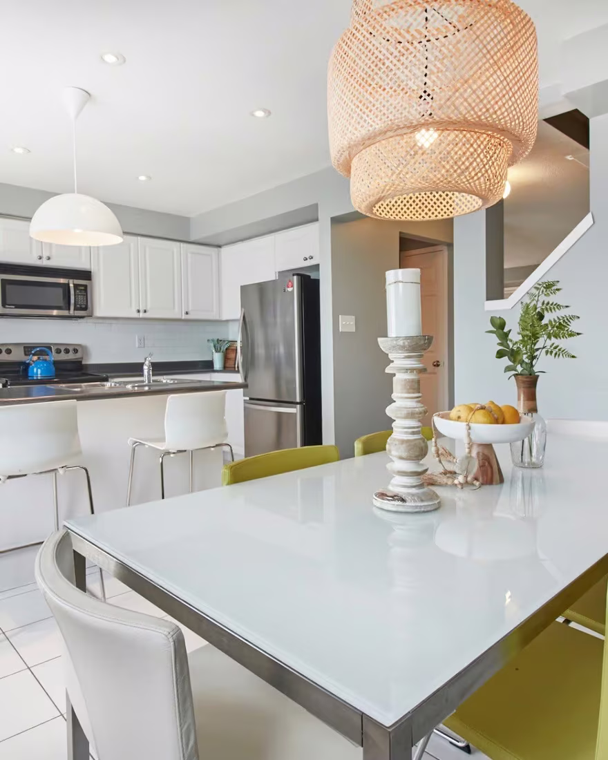Kitchen after staging, styled with a rattan pendant light and a coordinated centerpiece
